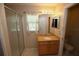Bathroom with shower, granite countertop, and wood cabinets at 1201 Thornbury Ct, Winter Garden, FL 34787