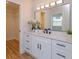 Modern bathroom with white cabinets, quartz countertop, and walk-in closet at 965 Tuskawilla Rd, Winter Springs, FL 32708