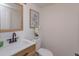 Simple half bathroom with light wood vanity and a modern toilet at 965 Tuskawilla Rd, Winter Springs, FL 32708