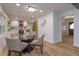 Dining area with glass table and chairs, adjacent to an updated kitchen at 965 Tuskawilla Rd, Winter Springs, FL 32708