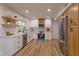 Modern kitchen with white and wood cabinets, stainless steel appliances, and quartz countertops at 965 Tuskawilla Rd, Winter Springs, FL 32708