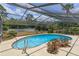 Inviting kidney-shaped pool with screened enclosure at 965 Tuskawilla Rd, Winter Springs, FL 32708