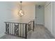 Modern staircase with metal railing and a geometric light fixture at 965 Tuskawilla Rd, Winter Springs, FL 32708