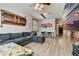 Spacious living room with L-shaped sectional sofa, wood-look floors, and large TV at 2938 Daybreak Dr, Orlando, FL 32825