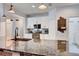 Modern kitchen with granite countertops, white cabinets, and a stylish faucet at 2938 Daybreak Dr, Orlando, FL 32825