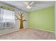Charming bedroom with painted tree mural and ceiling fan at 2938 Daybreak Dr, Orlando, FL 32825