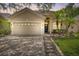 Tan house with a two car garage, and a nicely landscaped yard at 2938 Daybreak Dr, Orlando, FL 32825