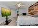 Main bedroom with wood wall, large TV and ensuite bath at 2938 Daybreak Dr, Orlando, FL 32825