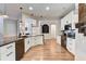 Open kitchen with white cabinets, granite counters, and a large island at 2938 Daybreak Dr, Orlando, FL 32825