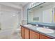 Shared bathroom with double vanity and updated flooring at 2938 Daybreak Dr, Orlando, FL 32825