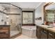 Spa-like bathroom with soaking tub, shower, and wood accents at 2938 Daybreak Dr, Orlando, FL 32825