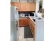 Galley kitchen with wood cabinets and granite counters at 933 W Oak Ridge Rd # 933 B, Orlando, FL 32809