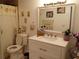 Bathroom with white vanity, toilet, shower, and decorative mirror at 933 W Oak Ridge Rd # 933 B, Orlando, FL 32809
