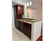 Kitchen boasts granite countertops and dark wood cabinets at 5132 Conroy Rd # 937, Orlando, FL 32811
