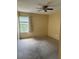 Second bedroom with window and carpeted floor at 5132 Conroy Rd # 937, Orlando, FL 32811