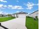 Single story home with two-car garage and landscaped lawn at 4305 Carrabelle River Ln, Lakeland, FL 33811