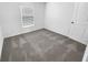 Simple bedroom with gray carpet and window with blinds at 4305 Carrabelle River Ln, Lakeland, FL 33811