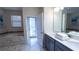 Primary bathroom with a large soaking tub, double vanity, and access to patio at 2965 Fable St, Kissimmee, FL 34746