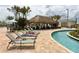 Relaxing resort-style pool with lounge chairs and a thatched-roof cabana at 2965 Fable St, Kissimmee, FL 34746