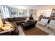 Open living area with sectional sofa, coffee table, and view into dining area and kitchen at 2965 Fable St, Kissimmee, FL 34746
