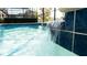 Close-up of waterfall feature flowing into the pool at 2965 Fable St, Kissimmee, FL 34746