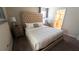 King-size bed with upholstered headboard, nightstands, and ensuite bathroom access at 2965 Fable St, Kissimmee, FL 34746
