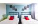 Two twin beds with superhero themed decor and red accents at 2965 Fable St, Kissimmee, FL 34746