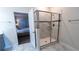 Bathroom with shower, tile flooring, and view into bedroom at 2965 Fable St, Kissimmee, FL 34746