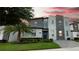Modern three-story home with stone exterior and landscaping at 2965 Fable St, Kissimmee, FL 34746