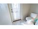 Small half bathroom with toilet and door to screened patio at 2965 Fable St, Kissimmee, FL 34746