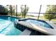 Inviting pool and spa with spillover and lake view at 2965 Fable St, Kissimmee, FL 34746