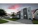 Modern home with stone accents in a row of similar houses at 2965 Fable St, Kissimmee, FL 34746