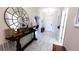 Bright entryway with a console table, mirror, and elegant tile flooring at 2965 Fable St, Kissimmee, FL 34746