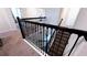 Elegant staircase with black wrought iron railing and carpeted steps at 2965 Fable St, Kissimmee, FL 34746