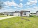 Newly built home with a two-car garage and manicured lawn at 4321 Carrabelle River Ln, Lakeland, FL 33811