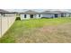 Spacious backyard with a grassy lawn and a privacy fence at 4321 Carrabelle River Ln, Lakeland, FL 33811