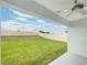 Covered patio overlooks a spacious backyard with a grassy lawn and privacy fence at 4321 Carrabelle River Ln, Lakeland, FL 33811