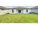 Spacious backyard with grassy lawn and patio at 4321 Carrabelle River Ln, Lakeland, FL 33811