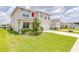 Two-story house with a landscaped front yard and attached garage at 418 Anne St, Deland, FL 32724