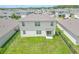 Aerial view of house and backyard with grassy lawn at 418 Anne St, Deland, FL 32724