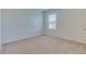 Empty bedroom with carpeted floors and a window at 418 Anne St, Deland, FL 32724