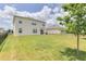 Large backyard with a grassy area and a black metal fence at 418 Anne St, Deland, FL 32724