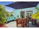Private patio with seating area, table and umbrella at 59 Chippingwood Ln, Ormond Beach, FL 32176