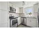 Modern kitchen with white cabinets and stainless steel appliances at 59 Chippingwood Ln, Ormond Beach, FL 32176