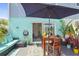 Private patio with seating area, table and umbrella at 59 Chippingwood Ln, Ormond Beach, FL 32176