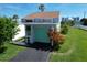 Charming light-green garage door with landscaping and driveway at 59 Chippingwood Ln, Ormond Beach, FL 32176