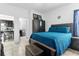 Bright bedroom with a queen bed and access to the kitchen at 139 Columbia Dr, Kissimmee, FL 34759