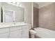Bathroom with white vanity, bathtub and gray tile at 7557 Laureate Blvd # 6208, Orlando, FL 32827