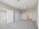 Spacious bedroom with gray carpet and an open door at 7557 Laureate Blvd # 6208, Orlando, FL 32827
