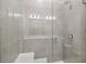 Walk-in shower with gray tile and glass enclosure at 7557 Laureate Blvd # 6208, Orlando, FL 32827